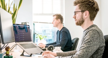 two men working with computers